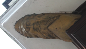 carved-face-on-eave